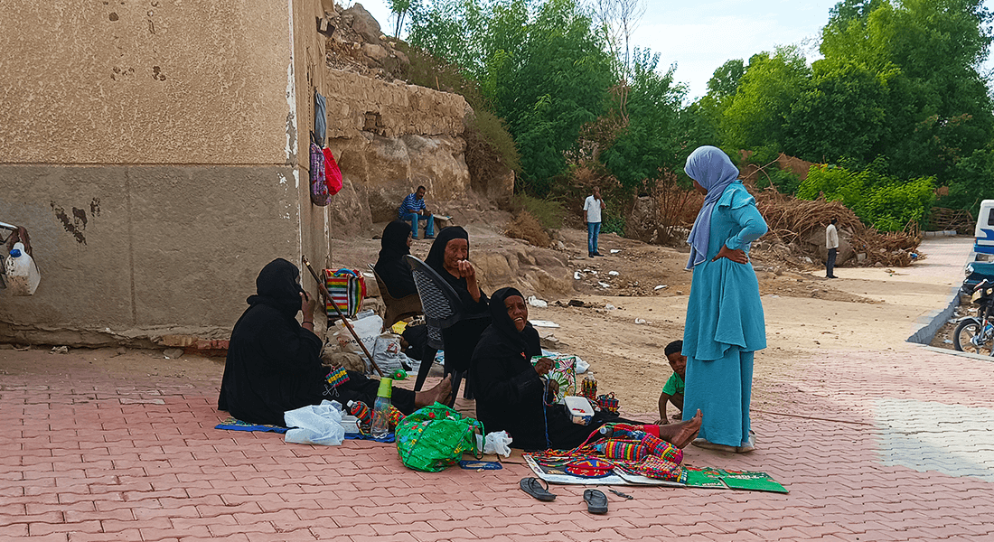 A group of Nubian women dressed in black gowns and tobes